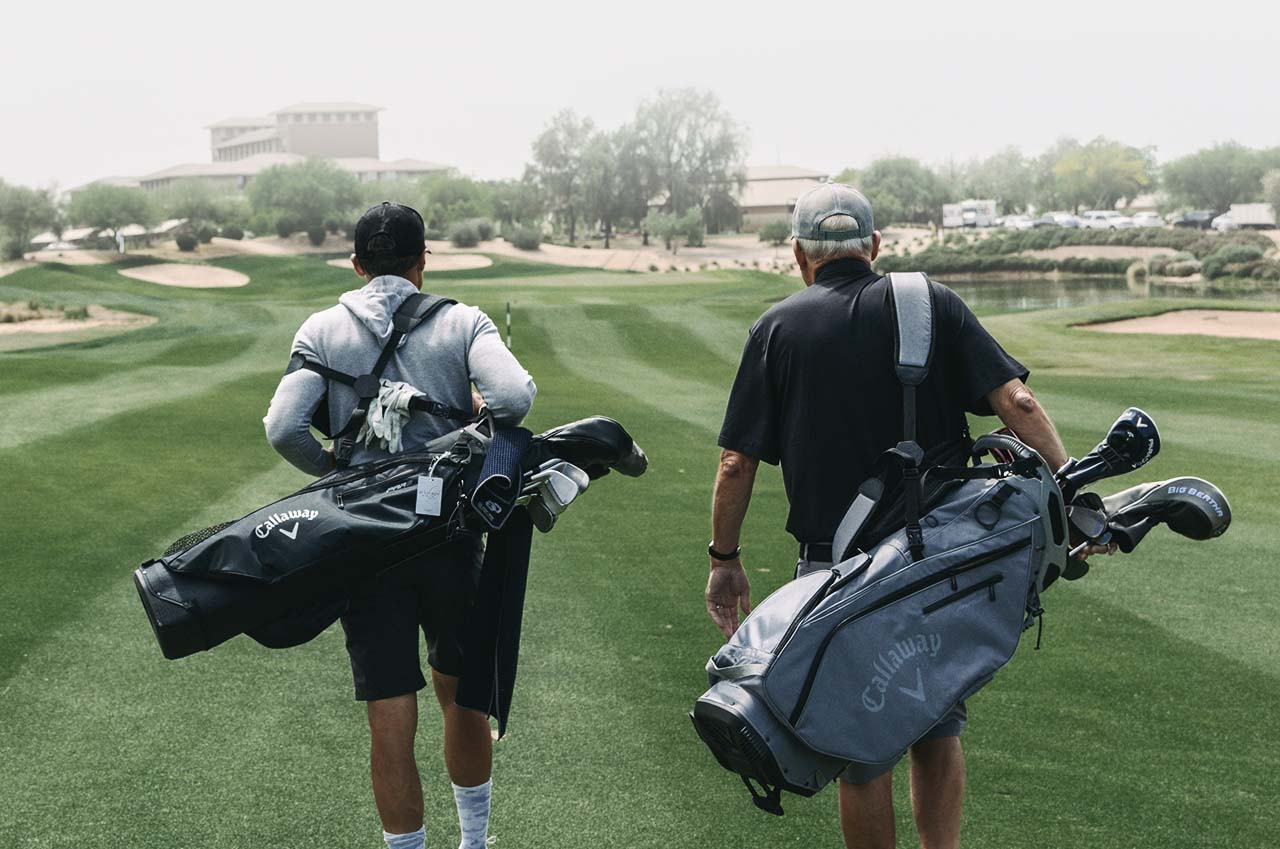 father and son walking a golf course